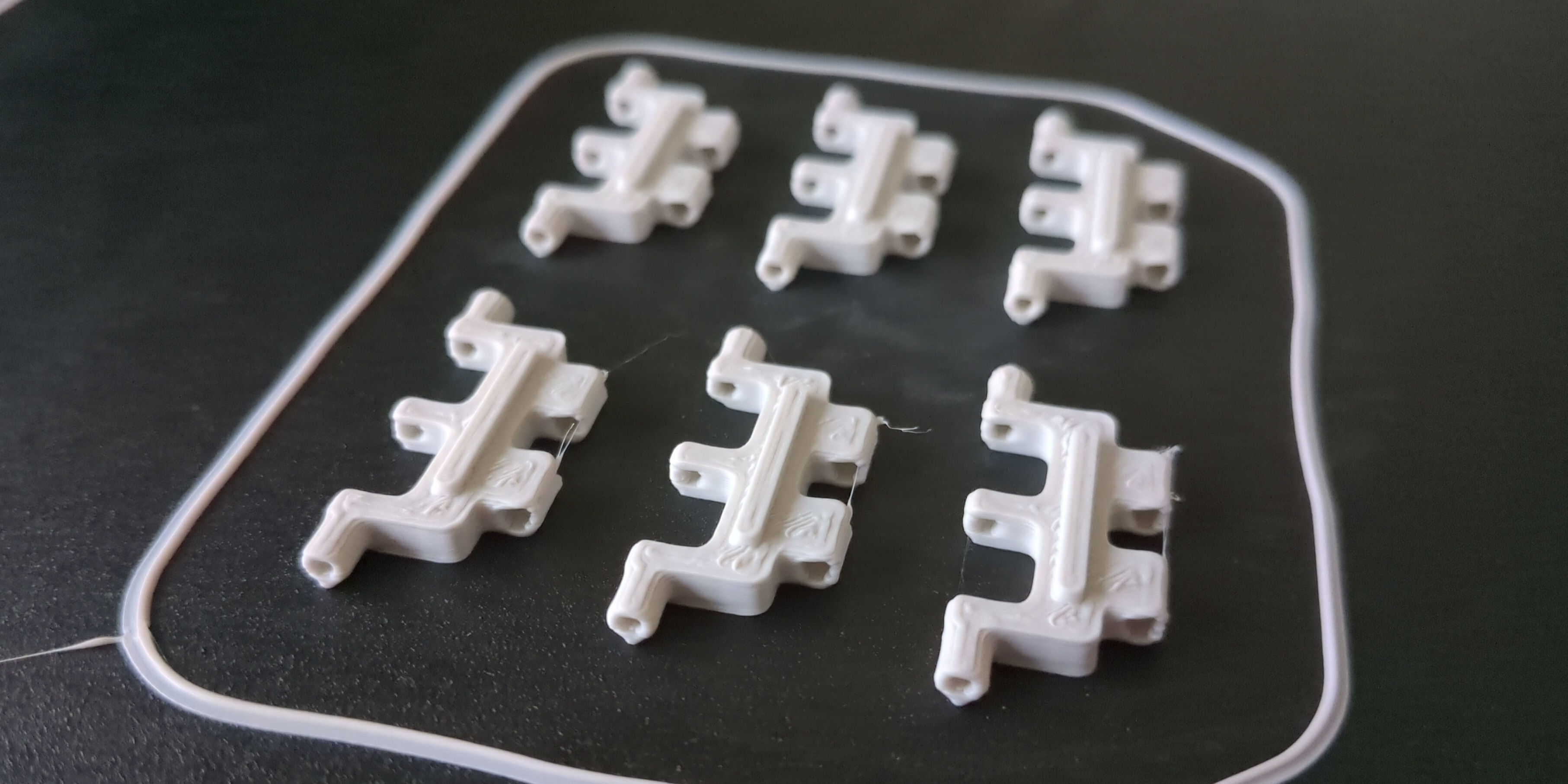 Track segments being 3D printed.